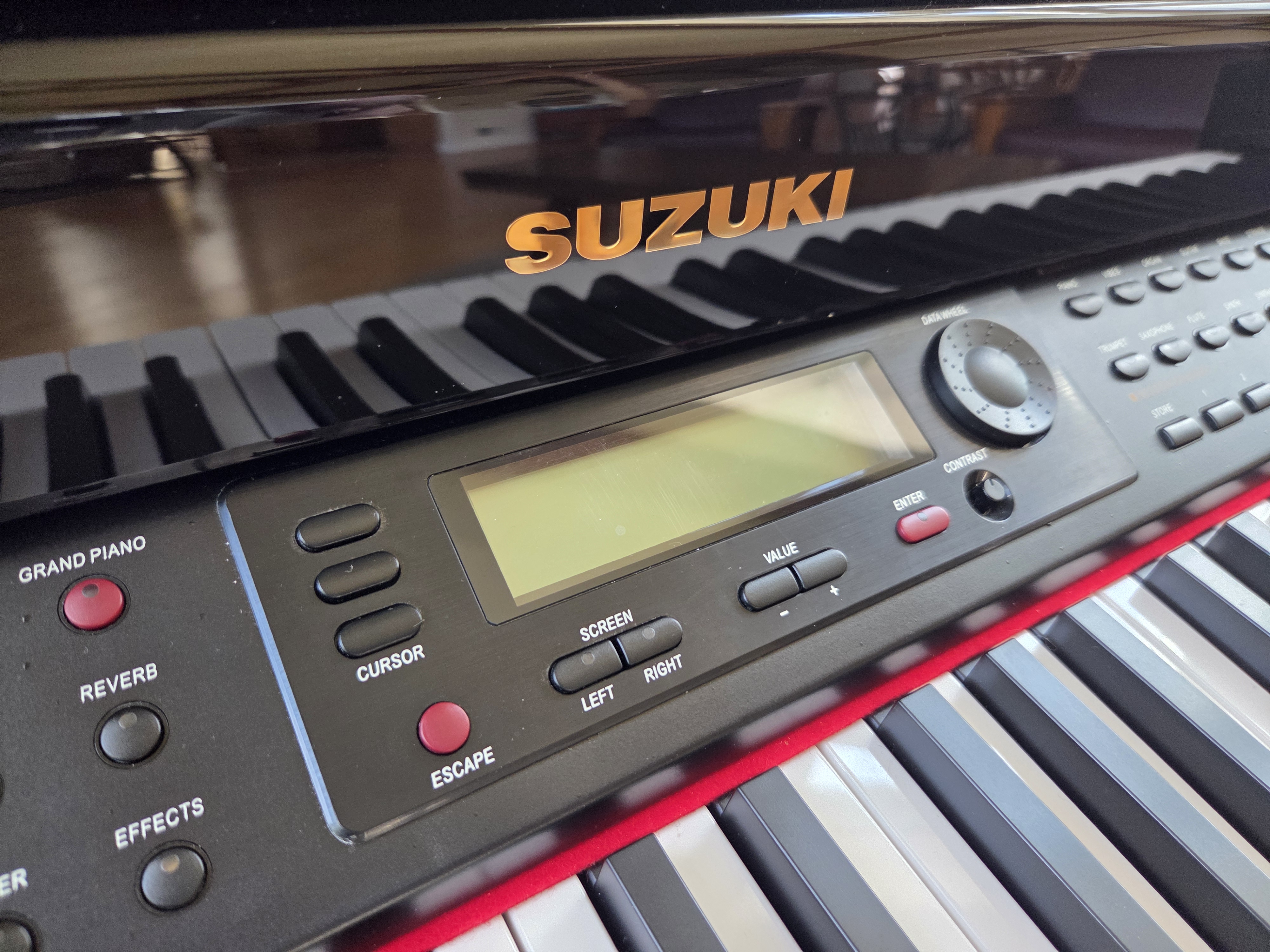 Suzuki digital player spinet piano with bench and discs | Maxsold
