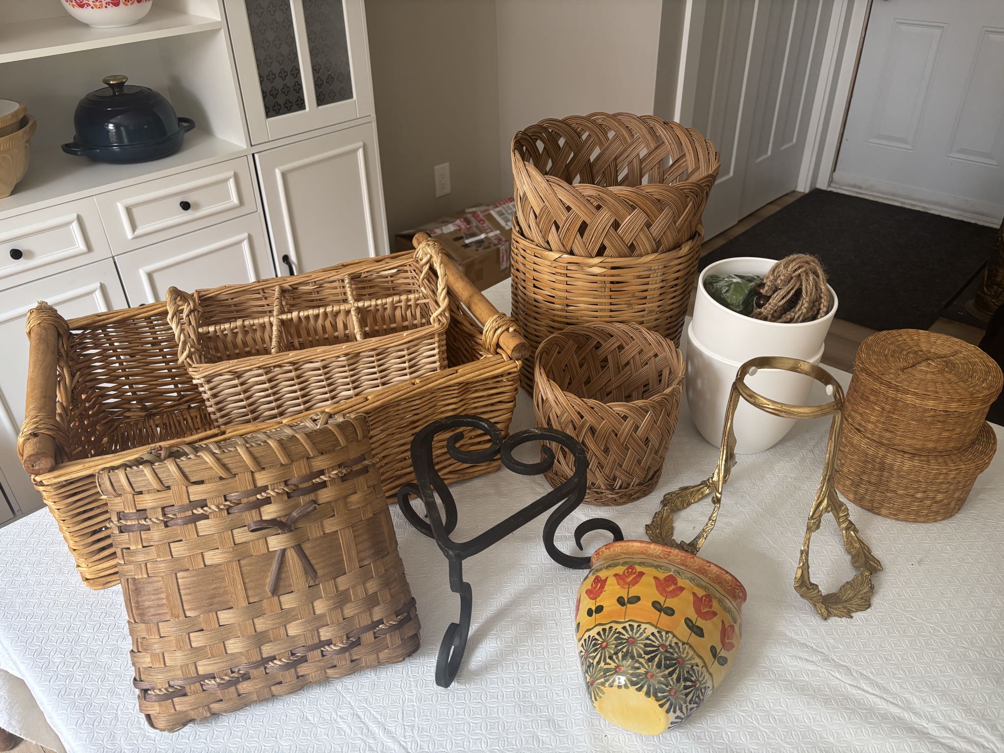Assorted wicker baskets, ceramic planters and stands | Maxsold