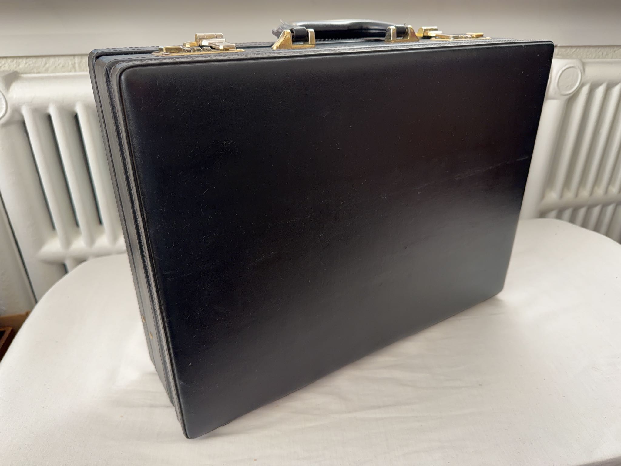 Black faux leather hard-sided briefcase with combination locks | Maxsold