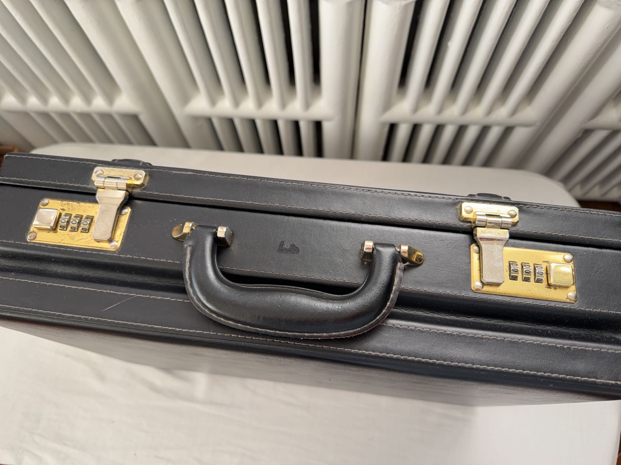 Black faux leather hard-sided briefcase with combination locks | Maxsold