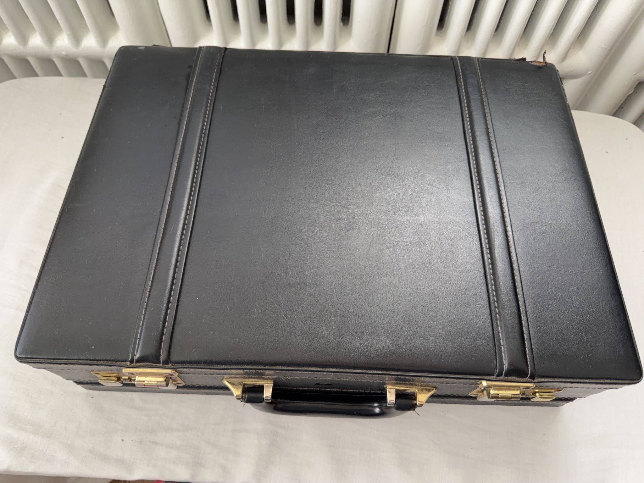 Black faux leather hard-sided briefcase with combination locks | Maxsold