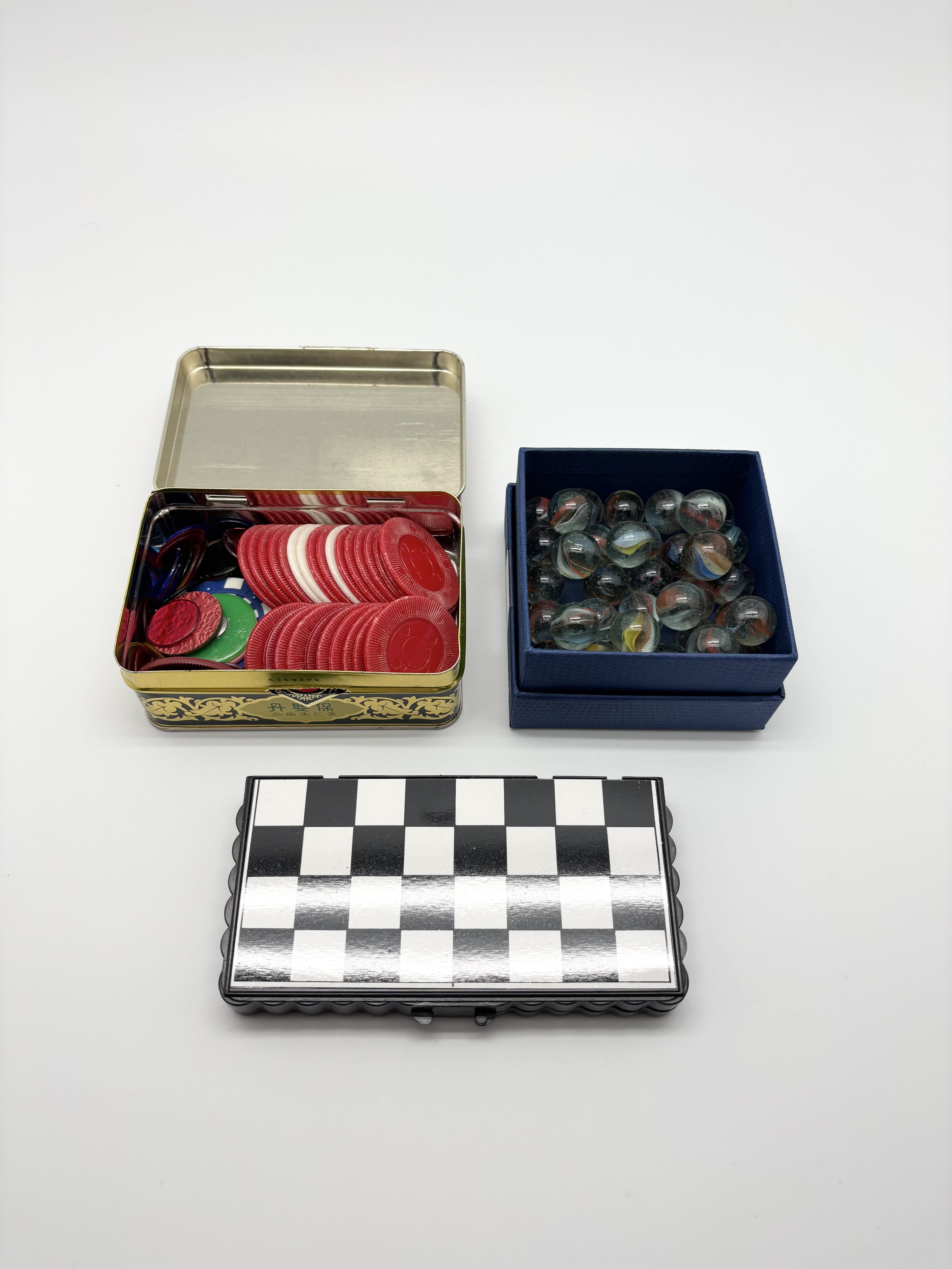 Mixed playing cards, poker chips, marbles and travel checker set | Maxsold